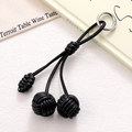 Detail of hand-woven black PU leather strap phone charm with triple sphere knots - Black