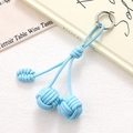 Close-up of light blue leather woven knot phone charm with silver metal ring buckle - Sky Blue