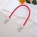 Red braided leather phone lanyard with silver metal lobster clasps on white stand - Red