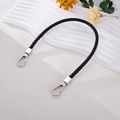 Detail of hand-woven black leather bag strap featuring sturdy silver metal swivel snap hooks - Black