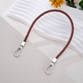Detail of hand-woven brown leather bag strap with durable silver metal lobster clasps - Coffee