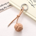 Macro detail of hand-woven leather ball bag charm with premium silver ring buckle - Khaki Braided Ball (K5241)