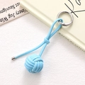 Detailed view of light blue hand-woven leather ball keychain with silver spring metal ring - Sky Blue Braided Ball (K5242)