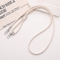 Detail of cream beige PU leather phone strap with silver alloy lobster clasps and metal slider - Cream Beige