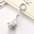 Detail view of a light grey braided leather ball keychain with silver metal spring ring - Gray Braided Ball (K5248)