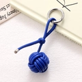 Close-up of royal blue hand-woven leather ball keychain with silver spring ring buckle - Dark Blue Braided Ball (K5249)