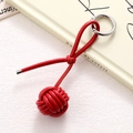 Macro detail of red leather woven ball charm with a polished silver spring ring clasp - Red Braided Ball (K5260)