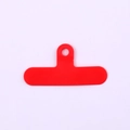 Detailed view of flexible red PVC phone tether tab with a reinforced lanyard hole - Clip / Red