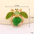 Detail view of gold-tone bee brooch with green enamel and measurements 3.9cm x 3.1cm - D3287 Apple Bee (Gold Green)