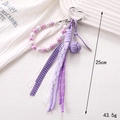 Detail of purple beaded pendant with woven ball and lace ribbon, length 25cm - Purple