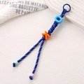 Detail of blue and white braided nylon keychain with colorful OK letter beads and charms - Royal Blue