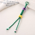 Macro detail of handmade green woven lanyard with yellow letter K and colorful beads - Dark Green