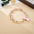 Pink ribbon and gemstone aluminum crossbody chain with gold metal links and bow detail - Rhinestone Ribbon Bow Hand Chain Pink