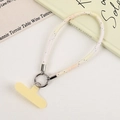 Detail of yellow T-patch and silver buckle on a checkered braided phone wrist strap - Light Yellow