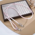 Detail of pink marble pattern PU leather crossbody strap with silver metal lobster clasps - Pink