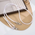 Detail of adjustable PU leather strap with silver metal hooks and lavender patterns - Purple