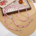 Dettaglio del cordino in perline di marmo rosa con fiocco di cristallo e ganci argento - Fiocco Rosa Rosso (K5497)