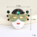 Detail view of a vintage mask charm with green rhinestones and size measurements - Gold Green Ball Mask (D3313)