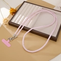 Close-up of pink beaded phone crossbody strap with silver lobster clasps and a soft pad - Pink