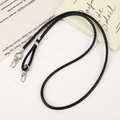 Detail of black woven PU leather phone lanyard with polished silver lobster clasp - Black