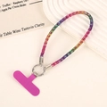 Detail of colorful rhinestone phone strap with a magenta T-shaped connector card - Colorful