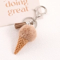 Detailed macro view of an ice cream shaped keychain with brown faux fur ball and resin cone - Light Brown