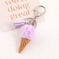 Detail of lavender faux fur pompom ice cream keychain with purple tassel and silver metal clasp - Purple