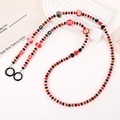 Detailed macro shot of handmade colorful m&m style beaded chain with secure black rings - Red Apple Style / Red