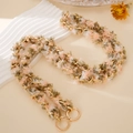 Detail of pink and green plush interwoven golden metal chain with round spring buckles - Fruit Green