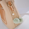 Beige leather handbag with double faux fur poms and pearl charm keychain decoration - Charm / Green