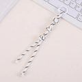 Macro shot of white hand-woven nylon bag charm with decorative knots and spring ring - White