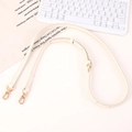 Adjustable cream leather bag strap featuring gold swivel clasps and functional holes - White