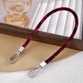 Detail of plush red leopard print phone strap with silver lobster clasps on display - Burgundy