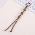 Detail of coffee-colored hand-woven Chinese knot bag pendant with white stitch texture - Khaki
