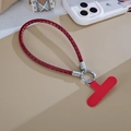 Burgundy woven PU leather phone lanyard with silver ring and spring clips on a table - Red