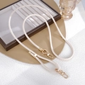 Detailed view of cream-colored snake-patterned braided strap with gold metal lobster clasps - Snake Pattern Leather Adjustable Crossbody Chain White (K5833)