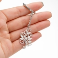 Polished stainless steel keychain featuring a delicate hollow vine leaf pattern pendant - 089