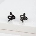 Macro shot of minimalist black snake studs on a textured stone display for clear detail - 274 Black