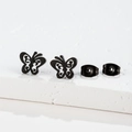 Macro shot of matte black stainless steel butterfly studs with hollow floral design - 267 Black