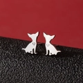 Minimalist silver chihuahua stud earrings with heart hollow design on red background - Chihuahua Silhouette (777) / Steel