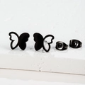 Macro detail of black butterfly stud earrings with matching butterfly backs on stone - 269 Black