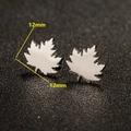 Detail macro view of maple leaf stud earrings in silver steel with 12mm dimensions - 651 Steel Color (Maple Leaf) / 12mm*12mm