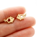 Cute gold stainless steel pig stud earrings with hollow heart design shown in hand - Pig (371) / Gold