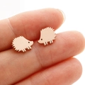 Detalle de mini pendientes de erizo en oro rosa sostenidos para mostrar tamaño - Estilo Erizo (365) / Rosa oro