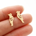 Detailed close-up of golden bird silhouette stud earrings with hollow wing patterns - Bird (373) / Gold
