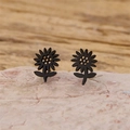 Details von mattschwarzen Sonnenblumen-Ohrsteckern mit Blattdesign auf Naturstein - 901 Schwarz (Sonnenblume)