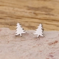 Minimalist silver Christmas tree stud earrings displayed on a natural stone surface - Christmas Tree Style (903) / Steel