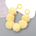 Short yellow faux fur ball phone wrist strap with white pearl accents and gold clasp - Yellow Style (K2850)