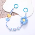 Blue and white beaded phone strap with crochet flower and heart charms on white background - Blue Flower Style (K2663)
