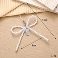 Elegant white pearl bow charm with silver metal clasp and portrait tag, 14cm length - Pearl Bow White
